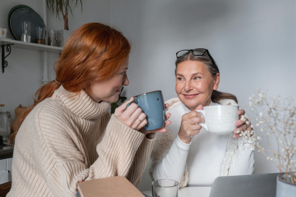 Woman in White and Gray Striped Long Sleeve Shirt Holding Blue Ceramic Mug